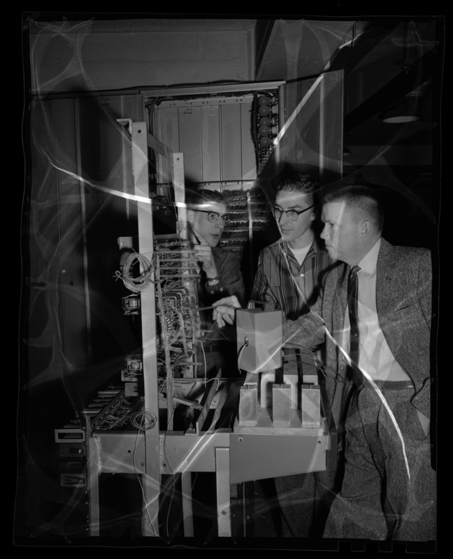 Professor of Electerical Engineering, Bill Parish (right) and students examining computator project.