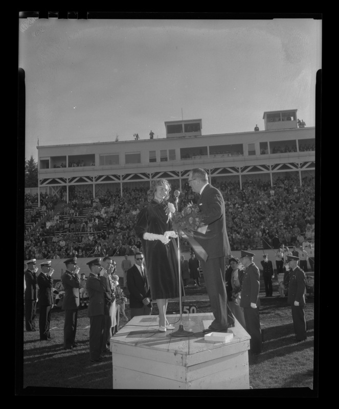 Homecoming queen Trenna Atchley being presented by Elbert Stellmon at the 1959 Homecoming Game.