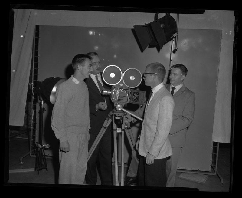 Bill Campbell, Ken Bell, Christian Nyby, and Drew McDaniels with a television camera.