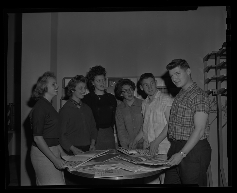 High school students attend journalism conference at the University of Idaho. Six students are pictured looking through yearbooks.