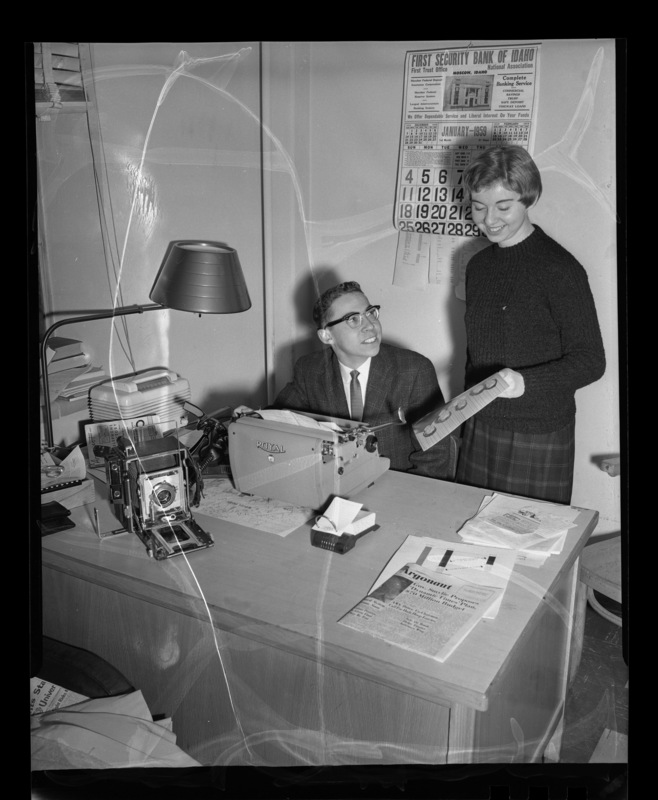 Jim Golden, Argonaut editor and Dama Wildig, women's editor, looking over a photograph.