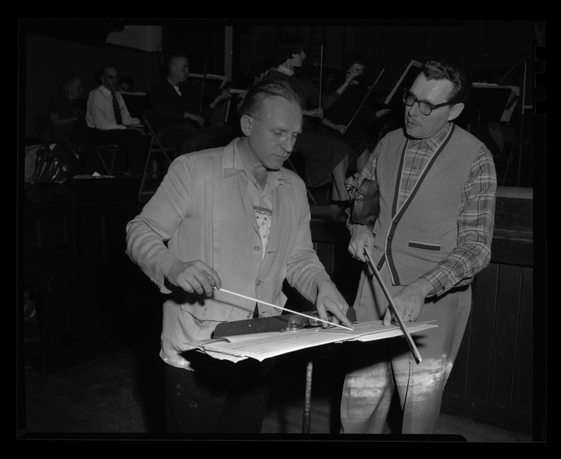 University Symphony Orchestra conductor, Professor LeRoy Bauer, and Spokane conductor Harold Paul Whelan discuss a musical score.