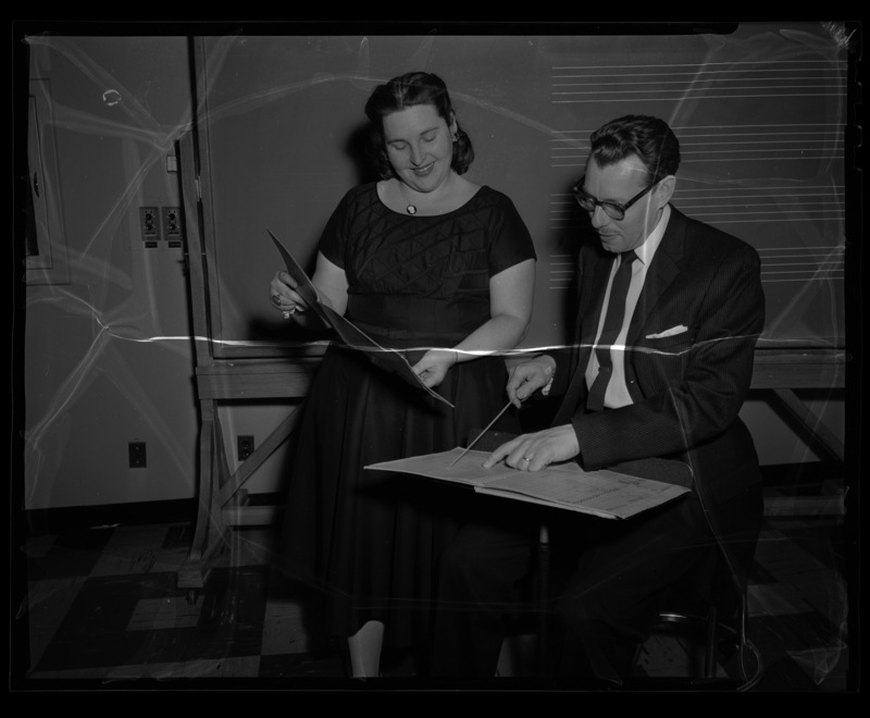 School of Music Professor LeRoy Bauer and sololist Mrs. Barnes looking over a score for a concert.