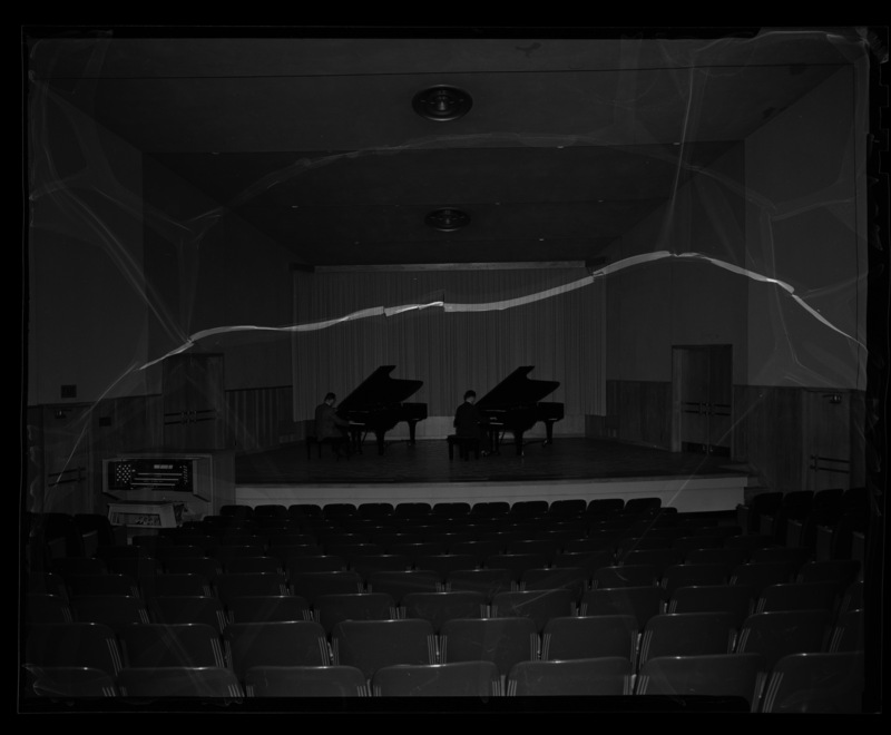 School of Music concert pianos played by two students in the music building's recital hall.