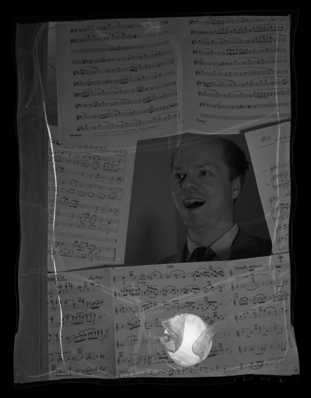 Dr. Raymond Tumbleson, visiting musical director and opera workshop director, sings surounded by sheet music.