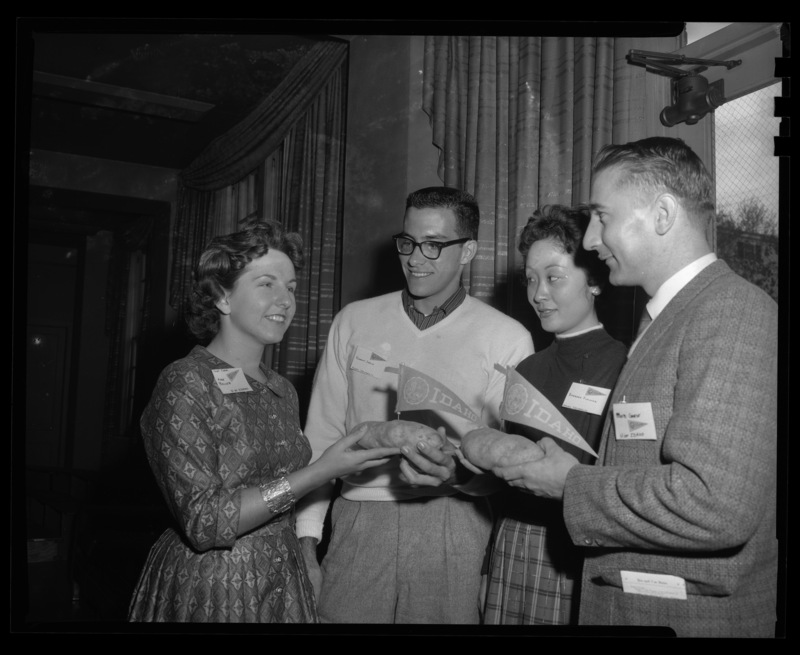 Students from University of Idaho give potatoes to University of Hawaii students (l-r): Ann Becker, Robert Jaroin, Barbara F., and Bob Gese at the Student Union Building.