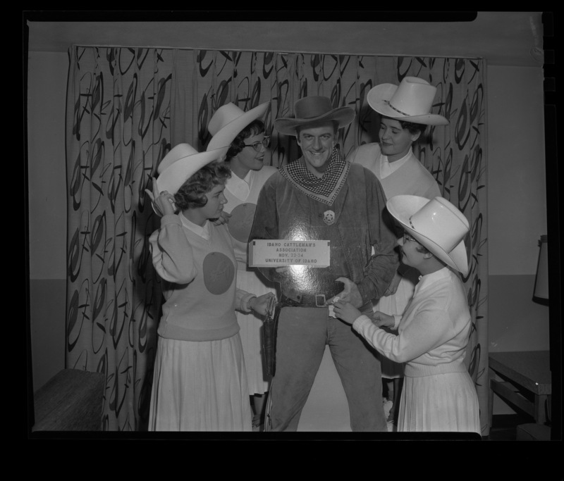 Four members of the Spurs (l-r) Sharon Lance, Linda Smith, Katherine Koelsch, and Blanche Blecha surround a cut out of Gunsmoke Star, James Arness that was used during the Idaho Cattlemen's Association meeting.