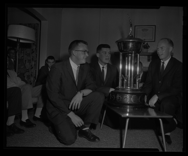 Members of Lambda Chi Alpha pose around the Sigma Chi Foundation's Scholarship Trophy, awarded to the UI chapter in 1959.