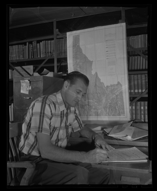 F. William "Bill" Bergeson, who served as Idaho State Senator for Bingham County while studying for his graduate degree in Agricultural Economics at a desk.