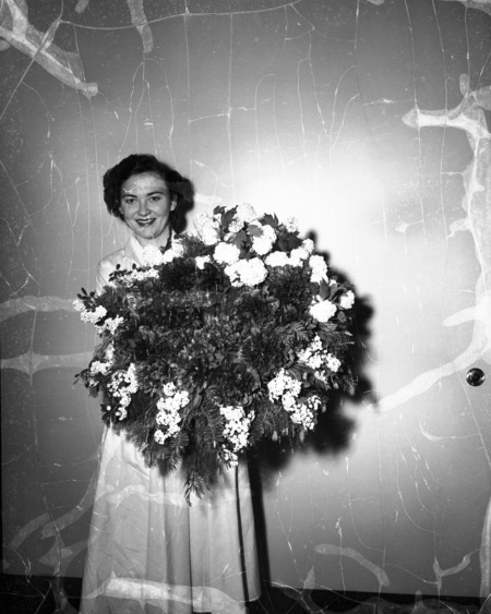Home Economics student showing off a large floral arrangement.