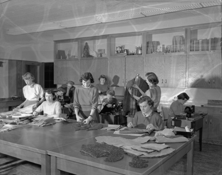 A group of Home Economics students cutting fabric and sewing for class.