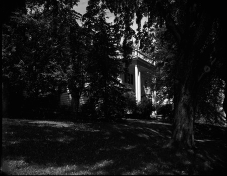A photograph of Kappa Gamma sorority house through the foliage.