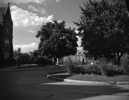 A photograph taken in front of the Administration Building, Life Sciences South Building can be seen in the background.