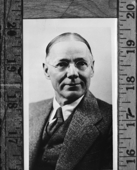 A portrait of Ronald B. Levison held against a ruler, author of In Defense of Plato and professor of philosophy at University of Maine.