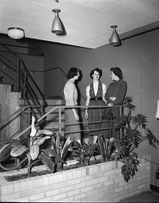 Three female students standing on the stairs in the Ethel Steel House. The Ethel Steel House was built in 1953, named after University of Idaho Regent Ethel Steel, as a housing option for women.