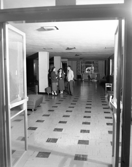 Three students socializing in a common area in the Student Union Building.