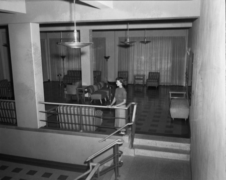 A student standing in a common area in the Student Union Building.