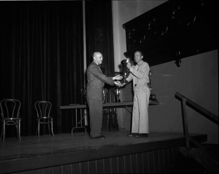 President Theophilus handing out awards at assembly.