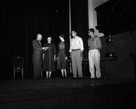 President Theophilus handing out awards at assembly.