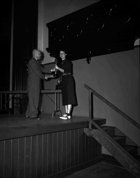 President Theophilus handing out awards at assembly.