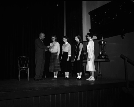 President Theophilus handing out awards at assembly.