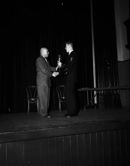 President Theophilus handing out awards at assembly.