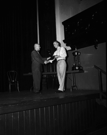 President Theophilus handing out awards at assembly.