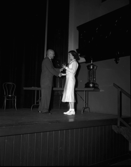 President Theophilus handing out awards at assembly.