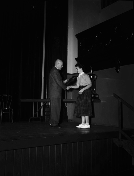 President Theophilus handing out awards at assembly.