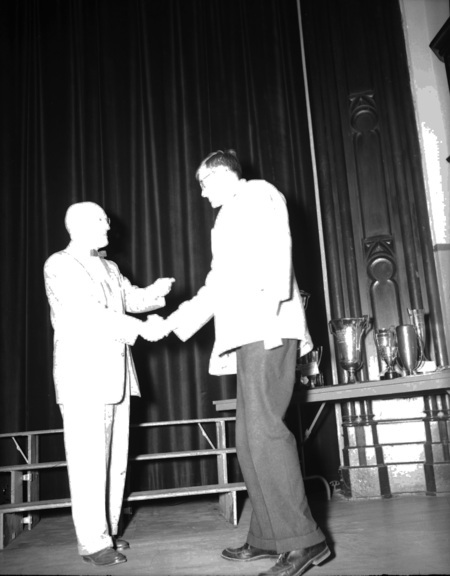 President Theophilus handing out awards at assembly.