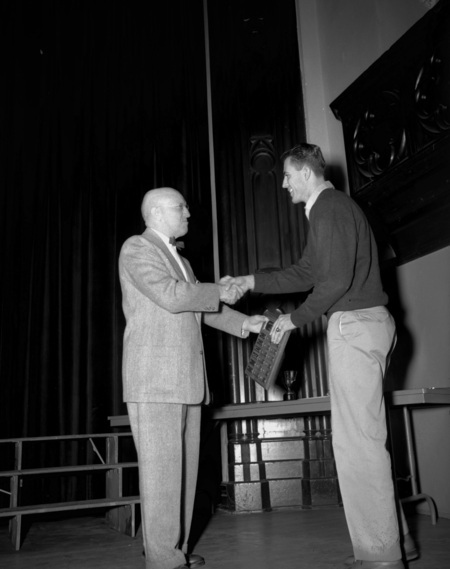 President Theophilus handing out awards at assembly.