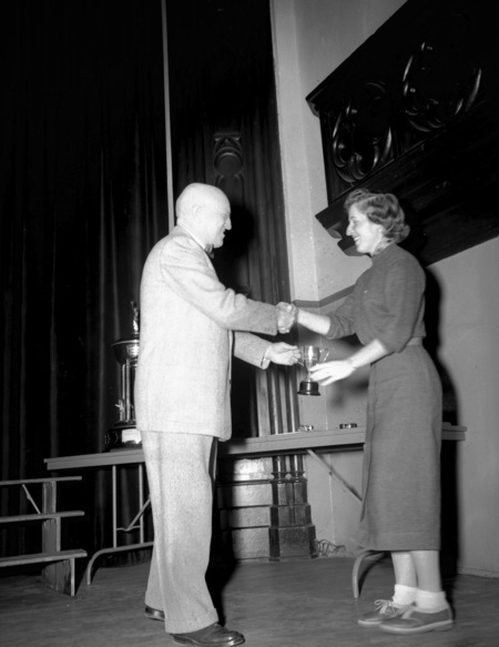 President Theophilus handing out awards at assembly.