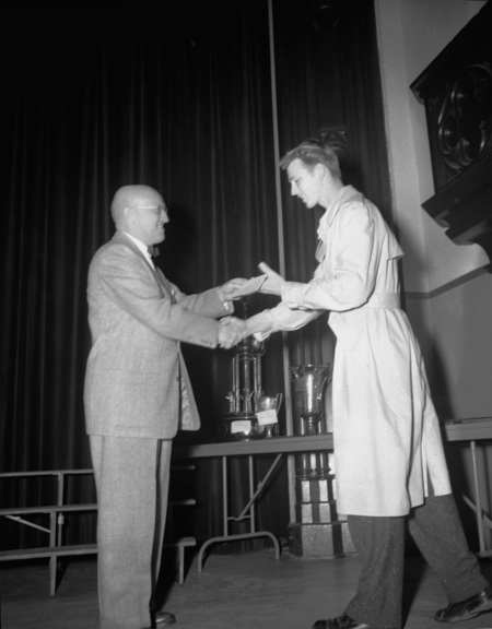 President Theophilus handing out awards at assembly.