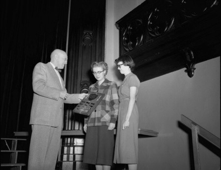 President Theophilus handing out awards at assembly.