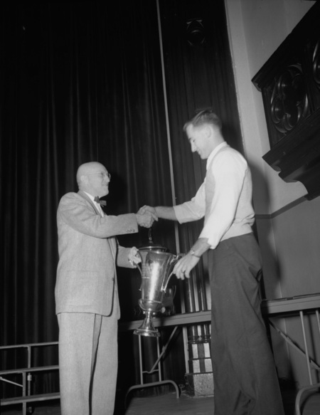 President Theophilus handing out awards at assembly.