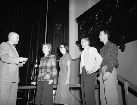 President Theophilus handing out awards at assembly.