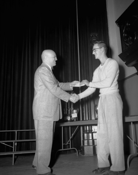 President Theophilus handing out awards at assembly.