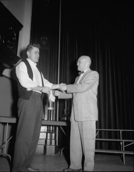 President Theophilus handing out awards at assembly.