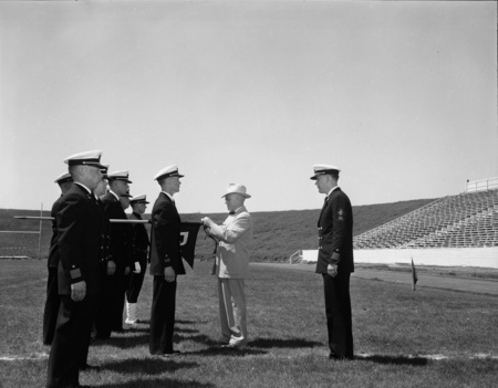 University President Theophilus giving out awards at Navy ROTC ceremony.