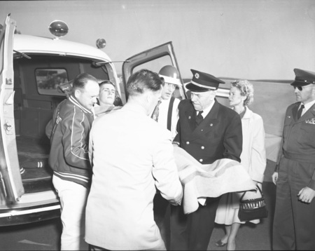 Man on a stretcher being loaded into an ambulance.