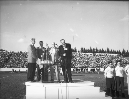 President Theophilus and others speak on stage during the Homecoming game.
