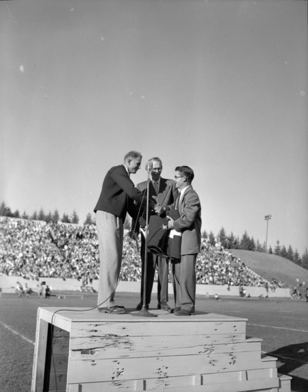 Speakers on stage at the Homecoming game.