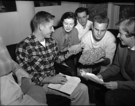 Students sit together to examine rock samples.