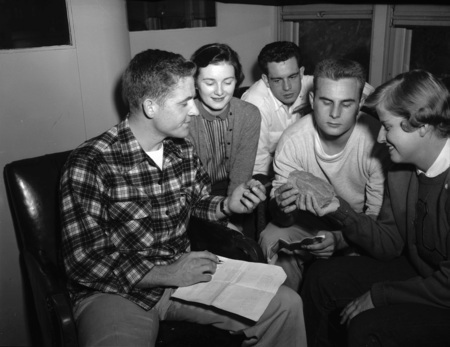 Students sit together to examine rock samples.