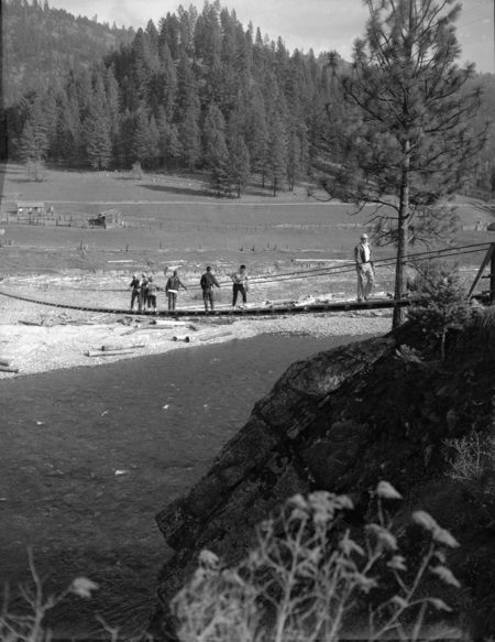 Students cross a rope bridge during geology field trip.