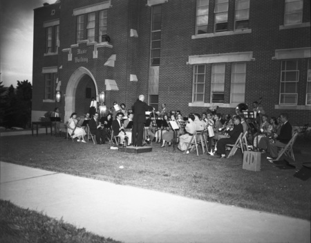 Students being led by conductor Carl Claus during outdoor orchestra practice outside of the Music Building.