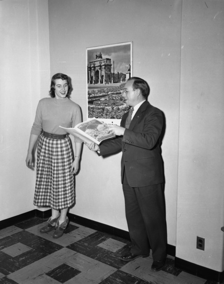 Two students looking at a book of music.