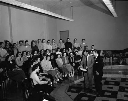 Choir practice being led by faculty.