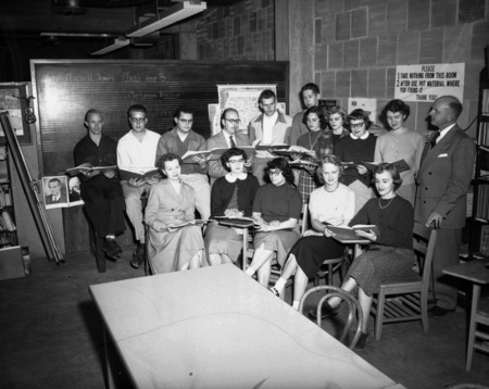 Students singing out of a song book.