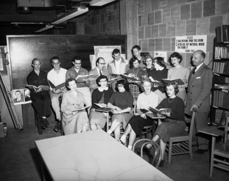Students singing out of a song book.